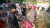 An injured migrant woman is moved by rescue personnel from the site of an accident near Tuxtla Gutierrez, Chiapas state, Mexico, Dec. 9, 2021. 