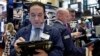 Trader Tommy Kalikas, left, works on the floor of the New York Stock Exchange, Sept. 6, 2016.