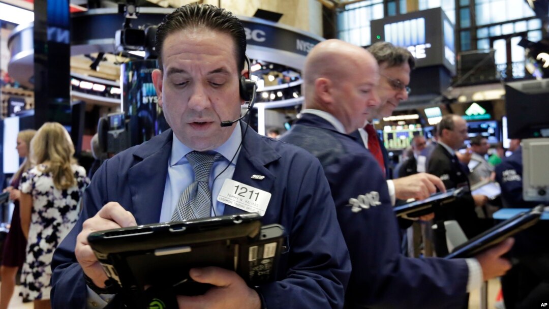 Trader Tommy Kalikas, left, works on the floor of the New York Stock Exchange, Sept. 6, 2016.