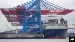 FILE - In this July 1, 2017 file photo containers are stacked on 'Zheng He' of China at the container terminal of the harbor of Hamburg, Germany. 