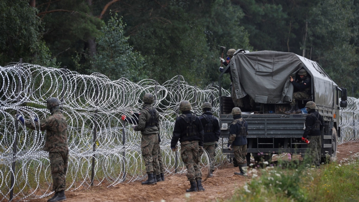 Polish police officers stop cars going in and out of an area along the  border with Belarus, where a state of emergency is in place, in Krynki,  Poland, Wednesday Sept. 29, 2021.