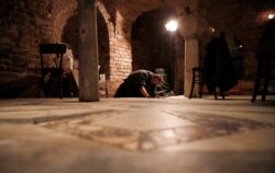 A man works in the St. Mark's Basilica crypt in Venice, Italy, Tuesday, Dec. 17, 2019.