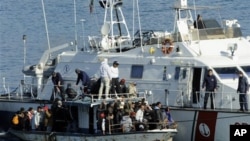 An Italian Coast Guard vessel rescues a boatload of would-be migrants believed to be from North Africa in the waters off the Sicilian island of Lampedusa, Italy, (File)