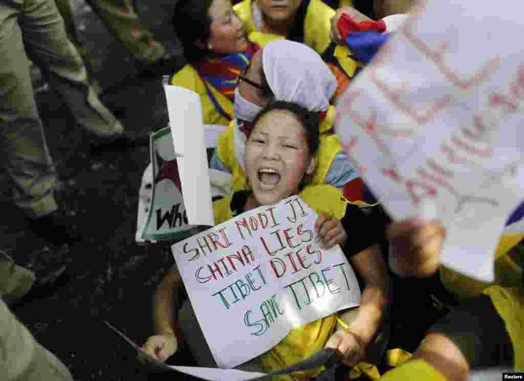 Tibetan exiles shout slogans as they are detained by police during a protest outside the venue of a meeting between Chinese President Xi Jinping and Indian Prime Minister Narendra Modi in New Delhi September 18, 2014. Groups of Tibetan activists held nois