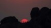 Excursionistas hacen una pausa para ver la puesta de sol en Papago Park durante una ola de calor donde las temperaturas alcanzaron los 115 grados Fahrenheit (46 grados Celsius) en Phoenix, el 15 de junio de 2021.