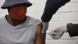 A vaccine volunteer gets an injection at the Chris Hani Baragwanath hospital in Soweto, Johannesburg Wednesday, June 24, 2020. The large-scale trial is being conducted for a vaccine candidate from AstraZeneca and the University of Oxford. (AP Photo/Siphiwe Sibeko)