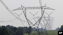 Electric lines extend over the hills of Owen County, near Owenton, Kentucky, July 22, 2011.