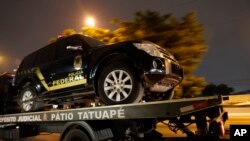 A fake police truck that was used in robbery is transported on a flat-bed truck in Sao Paulo, Brazil, July 25, 2019. 