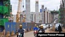 FILE - Motorists drive near a construction site of the Nairobi Expressway, undertaken by the Chinese contractor China Road and Bridge Corporation, in Nairobi, Kenya, July 12, 2021. A new report says China's investment in Kenya has dropped significantly. 