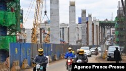 FILE - Motorists drive next to the ongoing construction site of the Nairobi Expressway, undertaken by the China Road and Bridge Corp., in Nairobi, Kenya, July 12, 2021. As Africa’s biggest investor, China has been responsible for major infrastructure projects in Kenya.