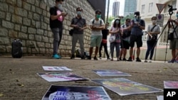 Pro-China supporters display a picture of U.S. President Donald Trump reading "Despicable and shameless" during a protest against the U.S. sanctions outside the U.S. Consulate in Hong Kong Saturday, Aug. 8, 2020. The U.S. on Friday imposed sanctions…