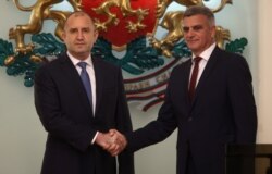 Newly-appointed caretaker Prime Minister Stefan Yanev, left, shakes hands with Bulgaria's President Rumen Radev during an official ceremony in Sofia, Bulgaria, May 12, 2021.