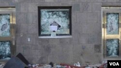 "Anything but the messenger of God," reads a sign left in the shattered window of a U.S. compound after it was stormed by rioters in Sana'a, Yemen, Sept. 13, 2012. (C. Coombs for VOA)