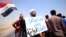 A protester holds a sign that reads "We ask the decision makers to provide the things we are deprived of" during a protest in south of Basra, Iraq, July 16, 2018. 