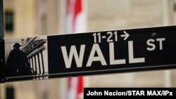 FILE - A view of street sign in front of New York Stock Exchange during the coronavirus pandemic on May 27, 2020 in New York City. 