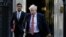 FILE - Britain's Prime Minister Boris Johnson, right, and Finance Minister Rishi Sunak, leave Downing Street to attend a cabinet meeting in London, Sept. 1, 2020. 