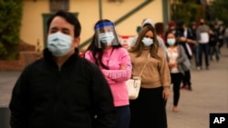 FILE - People wait in line for COVID-19 testing in Los Angeles, Dec. 7, 2020.