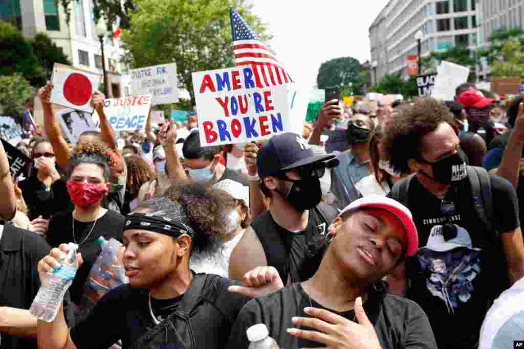 TiMia White of Washington, right, dances as she protests June 6, 2020, near the White House in Washington, over the death of George Floyd.