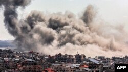 Smoke plumes billow after Israeli bombardment over Rafah in the southern Gaza Strip on March 20, 2024, amid ongoing battles between Israel and the Palestinian militant group Hamas.