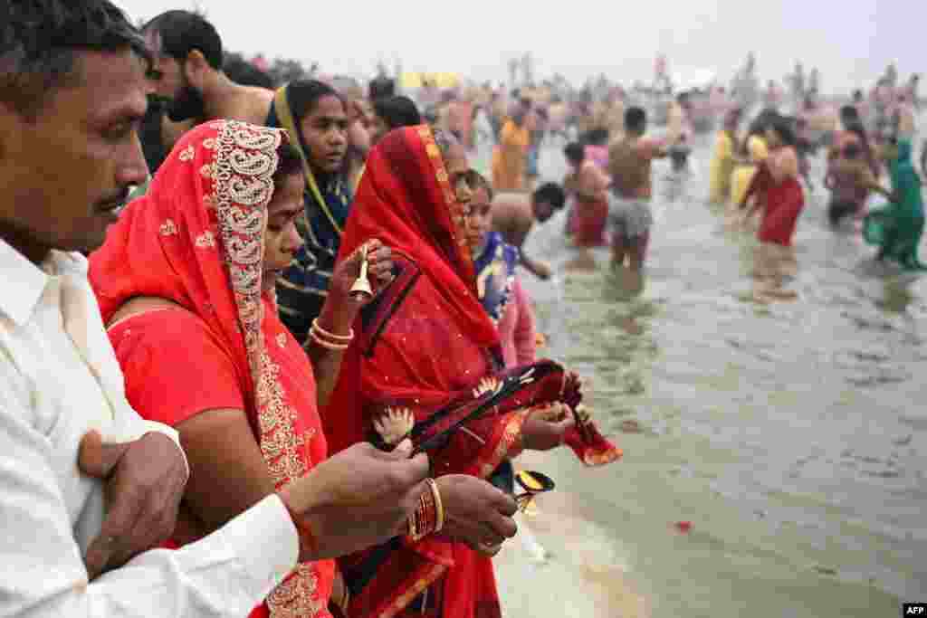 Hindu pilgrims offer prayers and take a dip in the sacred waters of Sangam, the confluence of Ganges, Yamuna and mythical Saraswati rivers during the Maha Kumbh Mela festival in Prayagraj on Jan. 13, 2025.