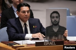 Ambassador Danny Danon, Israel's U.N. representative, holds a picture of Hersh Goldberg-Polin, a Hamas hostage whose body was found in the Gaza Strip, during a Security Council meeting about the Israel-Hamas conflict, in New York, Sept. 4, 2024.