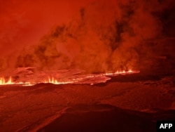 This handout picture released by the Icelandic Coast Guard on Feb. 8, 2024, shows smoke and lava coming out of a new fissure during a new volcanic eruption on the outskirts of the evacuated town of Grindavik, Iceland.