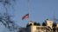 An American flag flies at half-staff in honor of the Connecticut elementary school shooting victims, over the White House in Washington, December 14, 2012.