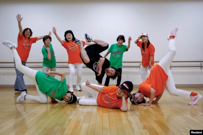 Members of Ara Style Senior, Japan's only breakdancing club made up of elderly citizens, and their teacher Yusuke Arai, 38, pose for a picture after their final rehearsal ahead of their performance at a festival in Tokyo, Japan, May 24, 2024. (REUTERS/Kim Kyung-Hoon)