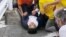 This screen grab shows former Japanese Prime Minister Shinzo Abe lies on the ground after he was shot from behind by a man during an election campaign for the July 10, 2022 Upper House election in Nara