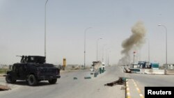 Smoke rises from a bomb attack in clashes between Iraqi security forces and Islamic State militants on the outskirts of Ramadi, April 9, 2015. 