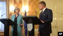 British Prime Minister Theresa May, left, speaks during a joint press briefing with Slovak Prime Minister Robert Fico, right, Bratislava, Slovakia, July 28, 2016. 