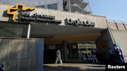 People are seen at the entrance of the maternity emergency unit at the Vall d'Hebron Hospital in Barcelona, Spain, July 25, 2016. A mother at the hospital has given birth to a baby with microcephaly. 