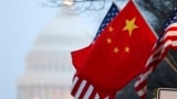 The People's Republic of China flag and the U.S. Stars and Stripes fly along Pennsylvania Avenue near the U.S. Capitol in Washington during Chinese President Hu Jintao's state visit