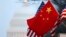 The People's Republic of China flag and the U.S. Stars and Stripes fly along Pennsylvania Avenue near the U.S. Capitol in Washington during Chinese President Hu Jintao's state visit