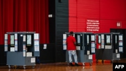 A voter casts his ballot in a polling place on Election Day in College Park, Georgia, Nov. 5, 2024.