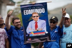 Supporters hold an electoral poster promoting opposition presidential candidate Edmundo Gonzalez Urrutia during the launch of his campaign for the July 28, 2024, election, in La Victoria, Venezuela, May 18, 2024.