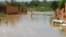 FILE: A child wades through water on a flooded street in the Kirkissoye quarter in Niamey on September 3, 2019. 