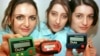 FILE - Three women hold the pager 'Quix' in Hannover, Germany, March 18, 1997. Pagers of many brands were status symbols decades before the smartphone wiped them from popular culture. But the devices remain a vital means of communication in some areas, such as healthcare.