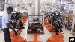 An employee works inside a plant of Ford Motor Co. in Maraimalar Nagar, about 50 km (31 miles) from the southern Indian city of Chennai February 5, 2010.