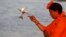 Mahant Trikaal Bhawanta, leader of the first group of women sadhvi, or Hindu holy women, performs evening rituals on the banks of River Yamuna in Allahabad, India. 