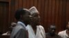 Radical Kenyan cleric Sheikh Abubakar Shariff, also known as Makaburi, right, with his lawyer, High Court in Mombasa, October, 2013. (Mohammed Yusuf/VOA)