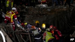 FILE—A survivor is bought to the surface at the scene of a building collapse in the city of George, about 400 kilometers (250 miles) east of Cape Town, South Africa, May 7, 2024.