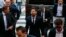 FILE - Barcelona soccer player Lionel Messi, center, arrives at court with his father, Jorge Horacio Messi, third from right, to stand trial for tax fraud in Barcelona, Spain, June 2, 2016. 