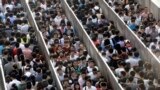 Passengers line up and wait for a security check during morning rush hour at Tiantongyuan North Station in Beijing. China tightened security checks at subway stations following an attack in country&#39;s troubled Xinjiang region which killed 31 people on May 22.