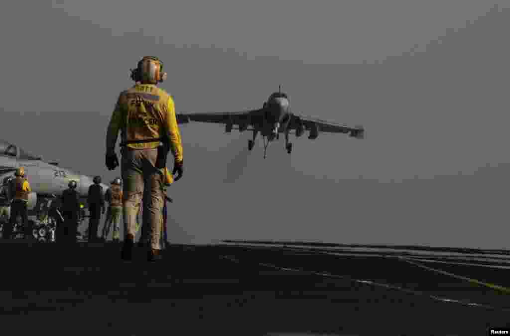 An F/A-18C Hornet coming from Iraq lands on the flight deck of U.S. Navy aircraft carrier USS George H.W. Bush on Sunday, August. 10, 2014, in the Persian Gulf.