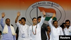 Rahul Gandhi, center, president of India's main opposition Congress party, waves to the crowd before addressing an election campaign rally ahead of the Karnataka state assembly elections, in Bengaluru, India, April 8, 2018.