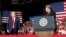 President Donald Trump listens Fox News' Sean Hannity speak during a rally at Show Me Center in Cape Girardeau, Mo., Nov. 5, 2018.