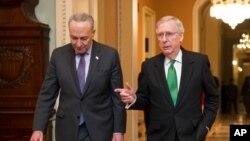 FILE - Then-Minority Leader Chuck Schumer, D-N.Y., left, and then-Majority Leader Mitch McConnell, R-Ky., walk to the Senate chamber at the Capitol in Washington, Feb. 7, 2018.
