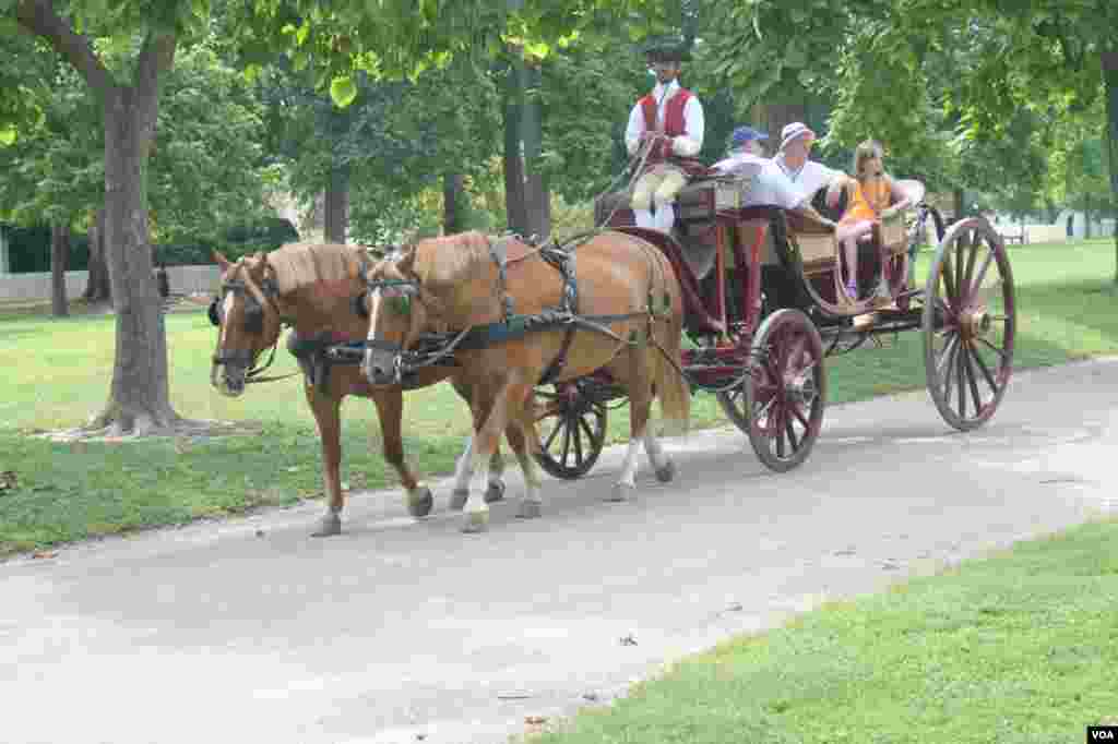 Tourists take a carriage ride in Colonial Williamsburg, Virginia. 