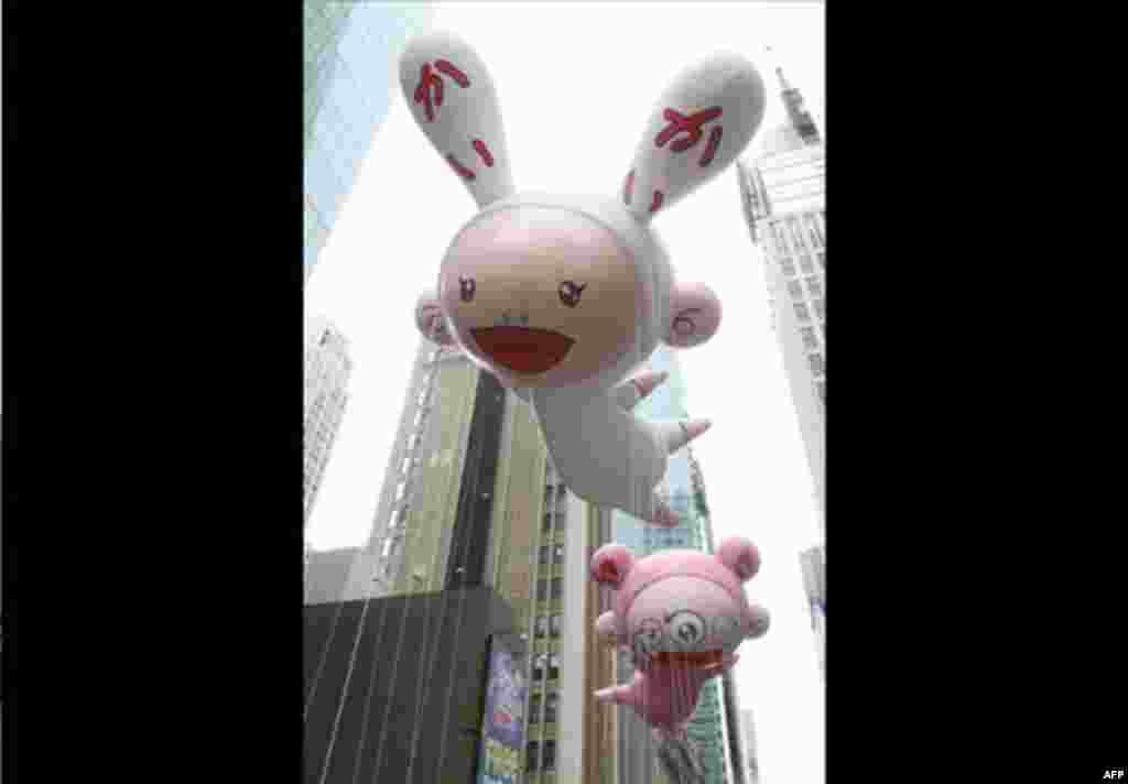 The Kaikai and Kiki balloons designed by Japanese artist Takashi Murakami make their way across 42nd Street during the Macy's Thanksgiving Day Parade on Thursday Nov. 25, 2010 in New York.